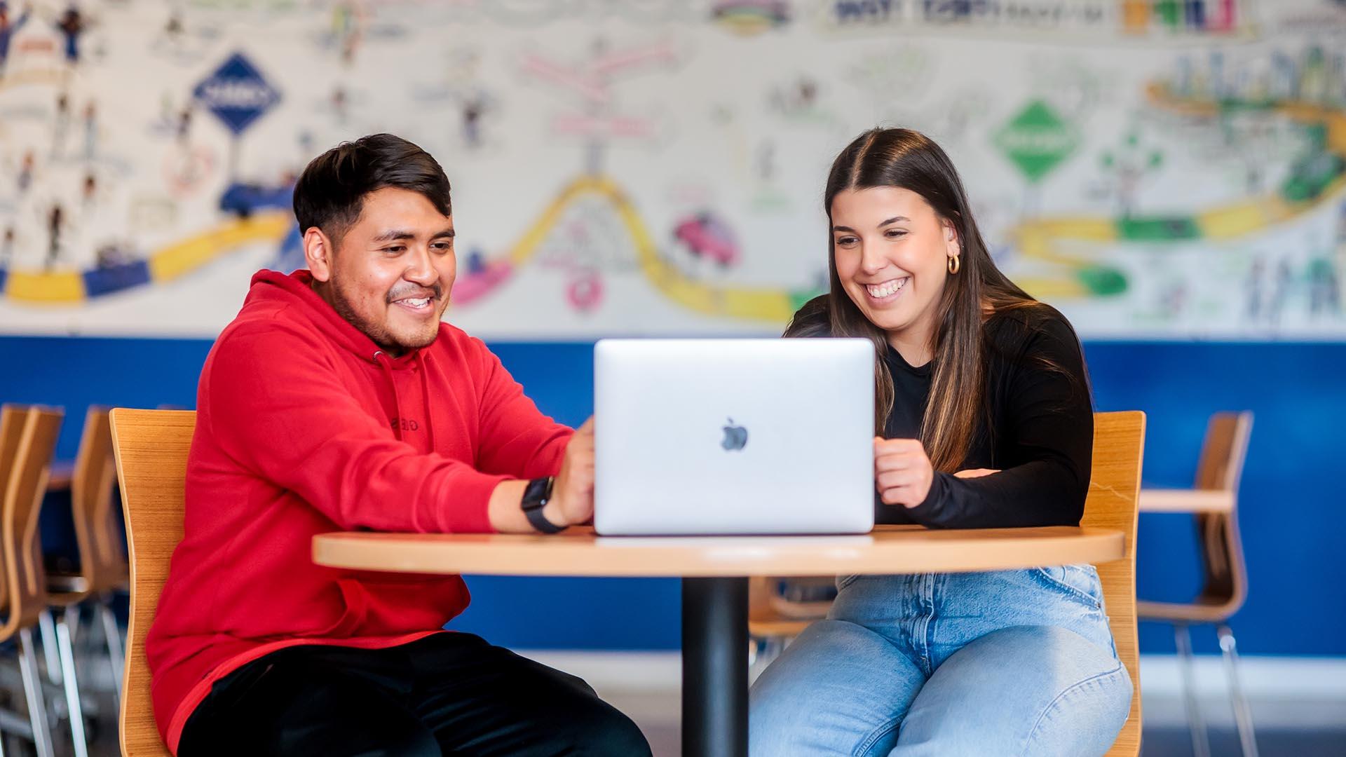 MSU Denver student Maria Dos Santos Oliveira helps Alejandro Reyes complete his class schedule and finalize his transfer to MSU Denver.